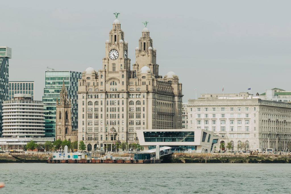 Scenic view of Liverpool's Royal Liver Building at the waterfront, showcasing architectural elegance.